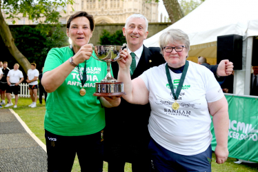 Therese lifting the tug of war trophy